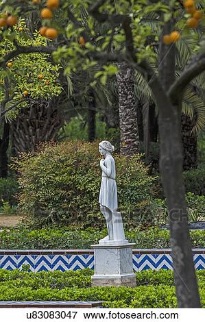 Stock Photo - Spain, Seville, Maria Luisa Park, Female statue in park. Fotosearch