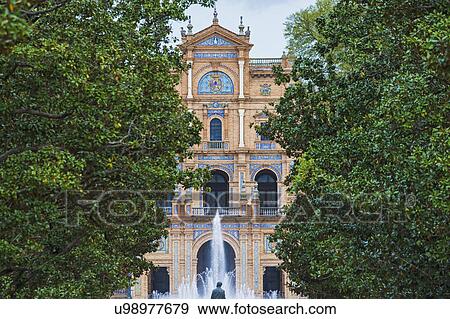 Spain, Seville, Plaza De Espana, Fountain among trees, building in background View Large Photo Image Stock Photo - Spain, Seville, Plaza De Espana, Fountain among trees, building in background. Fotosearch