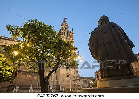 Spain, Seville, Plaza Virgin De Los Reyes, Statue and Giralda Tower at dusk View Large Photo Image Stock Image - Spain, Seville, Plaza Virgin De Los Reyes, Statue and Giralda Tower at dusk. Fotosearch