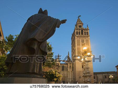 Stock Photography - Spain, Seville, Plaza Virgin De Los Reyes, Statue and Girlada Tower. Fotosearch