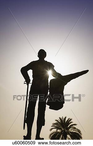 Stock Photo - Spain, Seville, Silhouette of statue of bullfighter Pepe Luis Vasquez in Plaza de Toros. Fotosearch