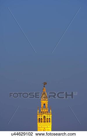 Stock Image - Spain, Seville, Tower of Giralda at dusk. Fotosearch