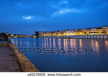 Spain, Seville, Triana, Guadalquivir river at dusk View Large Photo Image Stock Image - Spain, Seville, Triana, Guadalquivir river at dusk. Fotosearch