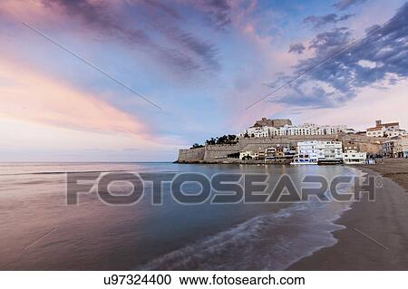Spain, Valencian Community, Peniscola, Waterfront town at sunset View Large Photo Image Stock Image - Spain, Valencian Community, Peniscola, Waterfront town at sunset. Fotosearch