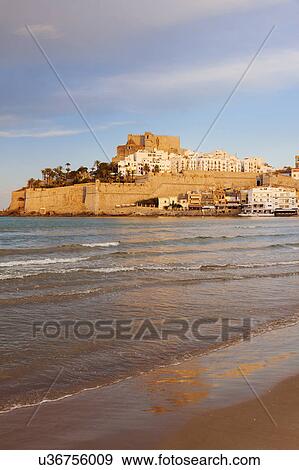 Stock Photo - Spain, Valencian Community, Peniscola, Waterfront town on hill with sea in foreground. Fotosearch