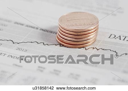 Stock Image - Stack of coins on stock market data. Fotosearch
