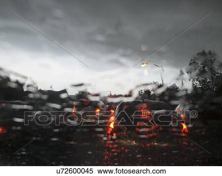 Stock Photography - Street traffic on rainy day. Fotosearch