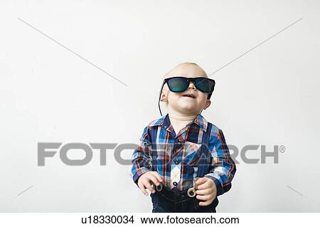 Studio shot of baby boy (12-17 months) wearing sunglasses View Large Photo Image Picture - Studio shot of baby boy (12-17 months) wearing sunglasses. Fotosearch