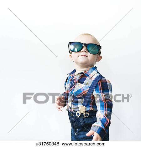 Studio shot of baby boy (12-17 months) wearing sunglasses View Large Photo Image Stock Photo - Studio shot of baby boy (12-17 months) wearing sunglasses. Fotosearch