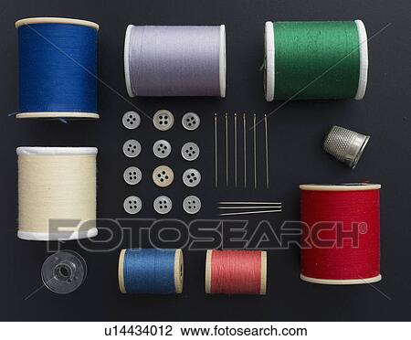 Stock Image - Studio shot of colorful sewing tools on black background. Fotosearch