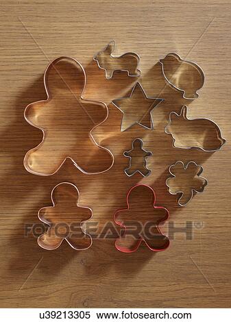 Stock Photography - Studio shot of cookie cutters on wooden table. Fotosearch