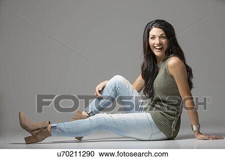 Studio shot of woman sitting on floor and laughing View Large Photo Image Stock Image - Studio shot of woman sitting on floor and laughing. Fotosearch