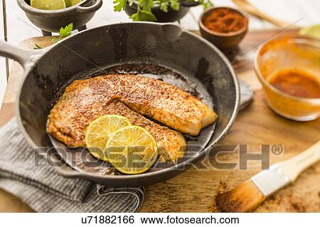 Tilapia on frying pan View Large Photo Image Stock Photograph - Tilapia on frying pan. Fotosearch