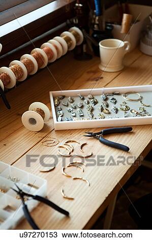 Stock Image - Tools and jewelry on table. Fotosearch