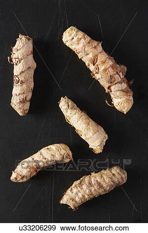 Stock Photo - Turmeric roots on black background. Fotosearch