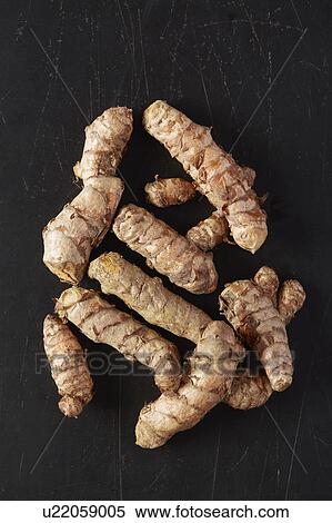 Stock Photography - Turmeric roots on black background. Fotosearch