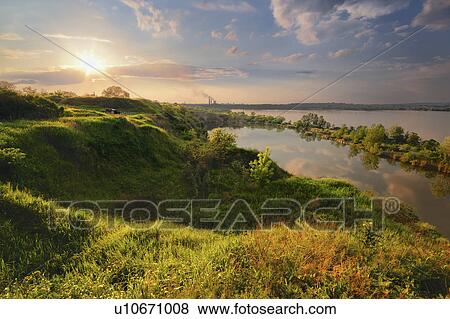 Stock Photo - Ukraine, Dnepropetrovsk, Landscape with pond and hills at sunset. Fotosearch