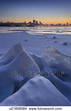 Picture - Ukraine, Dnepropetrovsk region, Dnepropetrovsk city, Frozen river with distant city skyline. Fotosearch