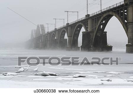 Stock Photo - Ukraine, Dnepropetrovsk region, Dnepropetrovsk city, Bridge over frozen river. Fotosearch