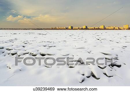 Ukraine, Dnepropetrovsk region, Dnepropetrovsk city, Frozen river with distant cityscape View Large Photo Image Stock Photo - Ukraine, Dnepropetrovsk region, Dnepropetrovsk city, Frozen river with distant cityscape. Fotosearch