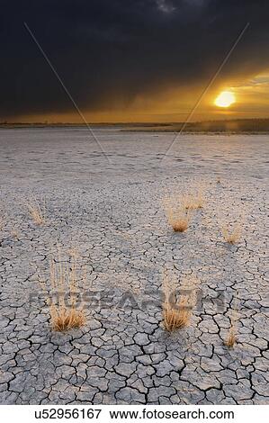 Stock Photo - Ukraine, Dnepropetrovsk Region, Novomoskovskiy District, Lake Soleniy Lyman, Stormy clouds over desert. Fotosearch