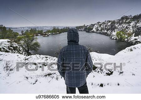 Ukraine, Dnepropetrovsk region, Dnepropetrovsk city, Person looking over winter landscape with lakes View Large Photo Image Stock Photography - Ukraine, Dnepropetrovsk region, Dnepropetrovsk city, Person looking over winter landscape with lakes. Fotosearch
