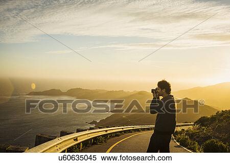 USA, California, San Francisco, California, Silhouette of man photographing coastline at sunset View Large Photo Image Stock Photography - USA, California, San Francisco, California, Silhouette of man photographing coastline at sunset. Fotosearch