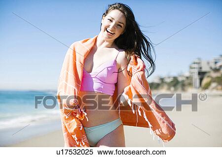 Stock Photography - USA, California, Woman standing by sea on Laguna Beach. Fotosearch