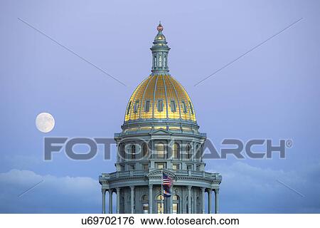 Stock Photograph - USA, Colorado, Denver, Full moon rising next to State Capitol dome. Fotosearch