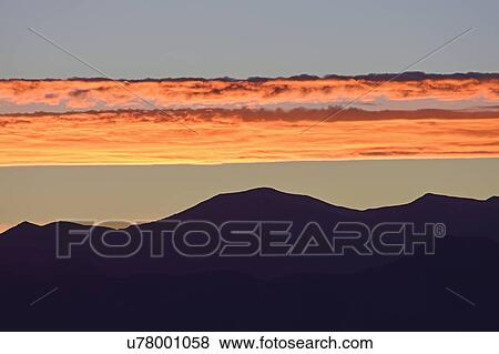 Stock Photo - USA, Colorado, Denver, Horizontal clouds over Front Range at sunset. Fotosearch