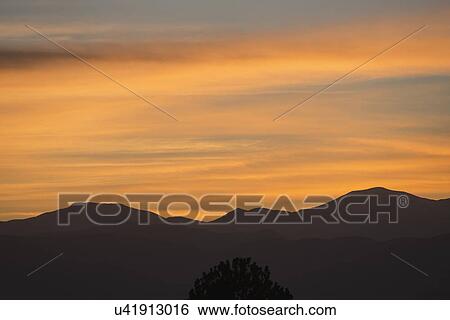Stock Photograph - USA, Colorado, Denver, Romantic sky over mountain range. Fotosearch