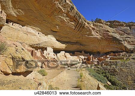 Stock Image - USA, Colorado, Long House pueblo ruin under cliff in Mesa Verde National Park. Fotosearch