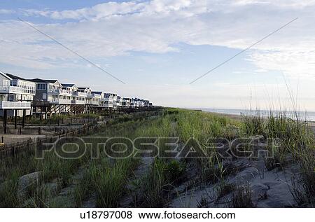 Stock Photo - USA, Delaware, Bethany Beach, Beach houses along sand dune. Fotosearch