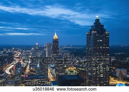 Stock Photograph - USA, Georgia, Atlanta, Cityscape with skyscrapers at dusk. Fotosearch