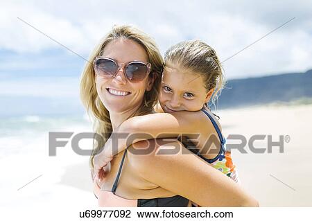 USA, Hawaii, Kauai, Mother with daughter (6-7) playing on beach View Large Photo Image Stock Image - USA, Hawaii, Kauai, Mother with daughter (6-7) playing on beach. Fotosearch