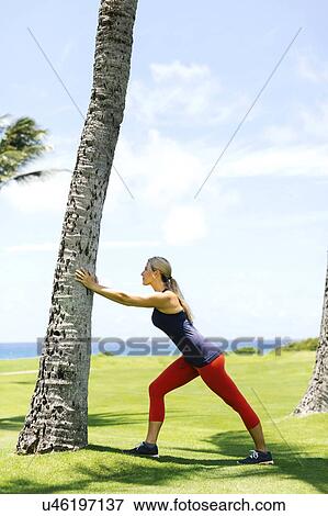 USA, Hawaii, Kauai, Woman exercising near sea View Large Photo Image Stock Photo - USA, Hawaii, Kauai, Woman exercising near sea. Fotosearch