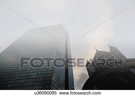 Stock Photography - USA, Massachusetts, Boston, John Hancock Tower and Trinity Church at Copley Square in fog. Fotosearch