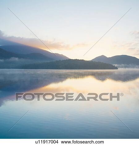 Picture - USA, New York, Adirondack Mountains, Lake Placid at sunrise. Fotosearch