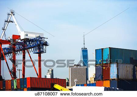 Stock Photo - USA, New York, New York City, Cranes in dock with cityscape in background. Fotosearch