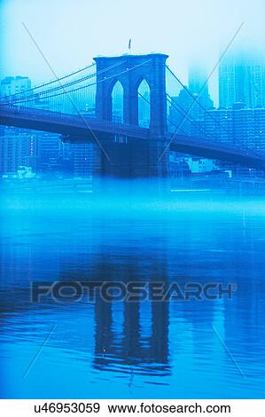 Stock Photo - USA, New York, New York City, Manhattan, Brooklyn Bridge over East River in fog. Fotosearch