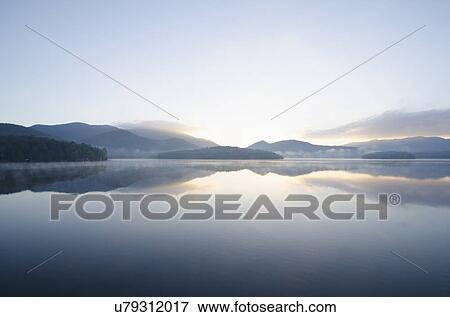 Stock Photo - USA, New York, St. Armand, Sunrise over Lake Placid. Fotosearch