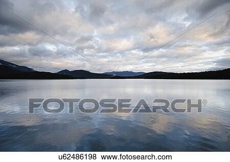 Stock Photo - USA, New York State, Evening sky over Lake Placid. Fotosearch