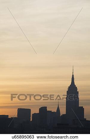 Stock Image - USA, New York State, New York City, Day breaks over Manhattan Island. Fotosearch