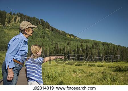 USA, Utah, Lake City, Girl (4-5) with grandmother standing on boardwalk by wetland View Large Photo Image Stock Photo - USA, Utah, Lake City, Girl (4-5) with grandmother standing on boardwalk by wetland. Fotosearch
