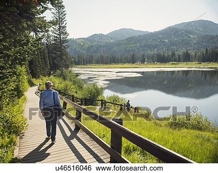 USA, Utah, Lake City, Grandparents with grandchildren (4-5) spending time by lake View Large Photo Image Stock Photograph - USA, Utah, Lake City, Grandparents with grandchildren (4-5) spending time by lake. Fotosearch