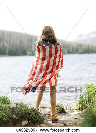 USA, Utah, Midway, Rear view of girl (8-9) wrapped in us flag standing by lake View Large Photo Image Stock Photo - USA, Utah, Midway, Rear view of girl (8-9) wrapped in us flag standing by lake. Fotosearch