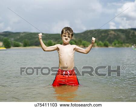 USA, Utah, Park City, Boy (6-7) flexing muscles while wading in lake View Large Photo Image Stock Image - USA, Utah, Park City, Boy (6-7) flexing muscles while wading in lake. Fotosearch