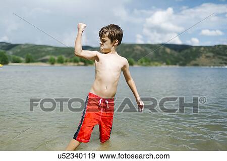 USA, Utah, Park City, Boy (6-7) flexing muscles while wading in lake View Large Photo Image Stock Photo - USA, Utah, Park City, Boy (6-7) flexing muscles while wading in lake. Fotosearch