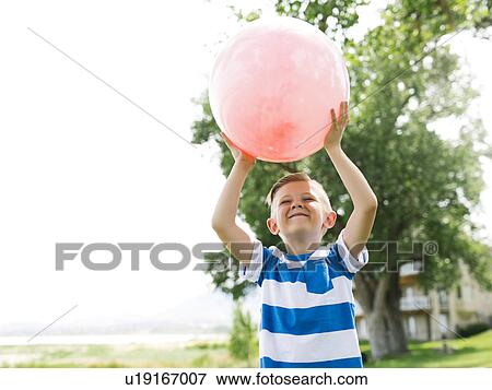 USA, Utah, Salt Lake City, Boy (6-7) playing with large pink ball View Large Photo Image Stock Photo - USA, Utah, Salt Lake City, Boy (6-7) playing with large pink ball. Fotosearch