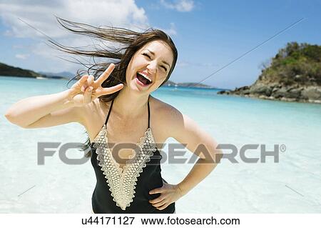 Stock Photo - USA, Virgin Islands, Saint Thomas, Beautiful woman having fun in ocean. Fotosearch